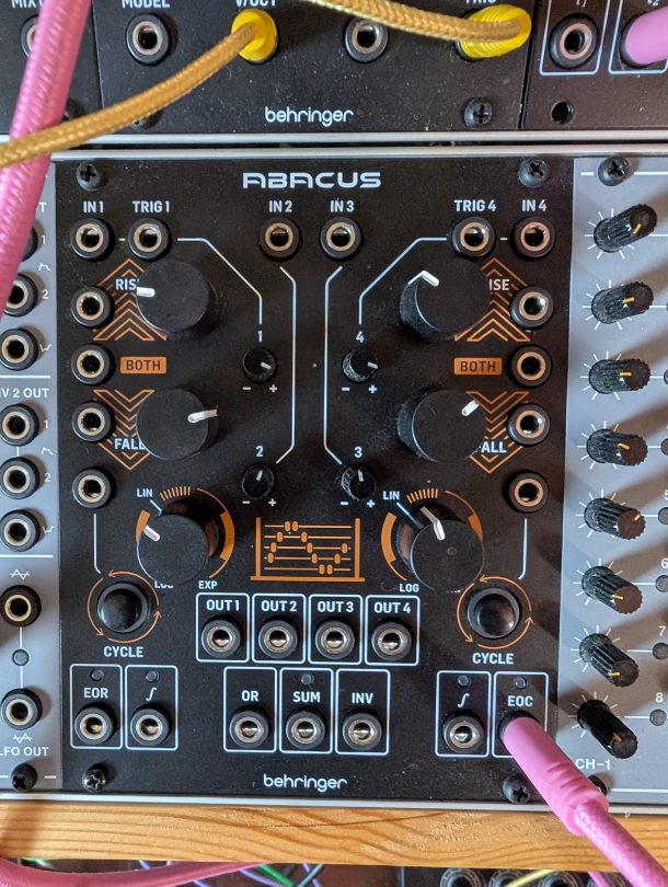 Behringer Abacus Eurorack module patched with cables in a rack, showing rise, fall, cycle, output and logic jacks