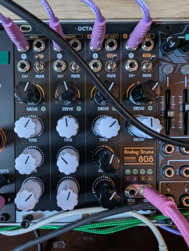 NANO Modules OCTA Eurorack drum module patched in a rack, showing kick, snare and hat voices with drive, tone and decay controls